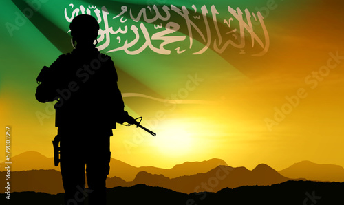 SIlhouette of a soldier against the sunset sky and Saudi Arabia flag. Concept - Armed Force of Saudi Arabia. National Holidays background. EPS10 vector