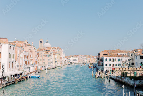 The great canal flows through Venice, taking its travelers with it. Everything shines in bright sunshine and the water shines turquoise. © Miriam