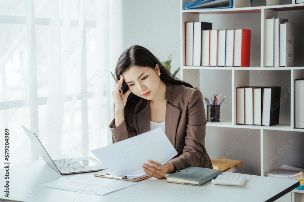 Asian businesswoman in formal suit in office happy and cheerful during using smartphone and working