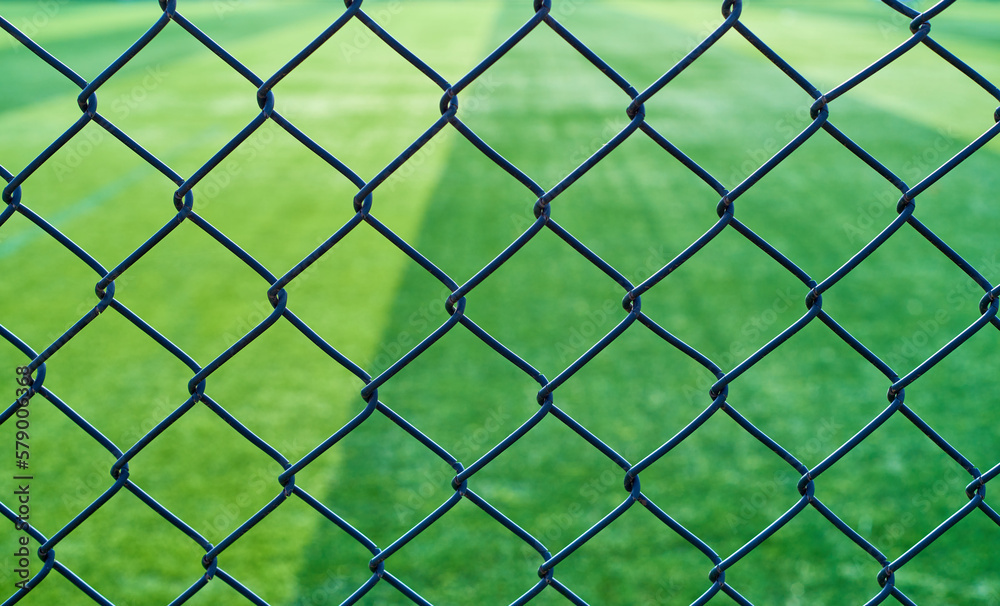 Barbed wire fence outside a football field Barbed wire fence outside a football field