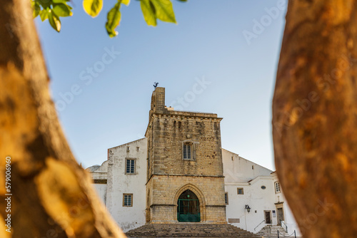 Downtown of Faro with Se Cathedral in the morning with orange tree in the foreground, Portugal