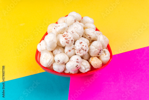 Organic Crispy Lotus pops Seeds or Phool Makhana served in a wooden bowl on background.