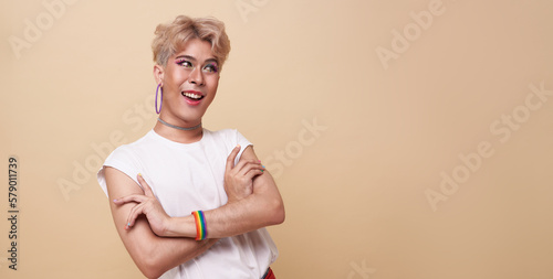 Bild auf Leinwand Happy teenage asian transgender LGBT isolated over nude color copy space background