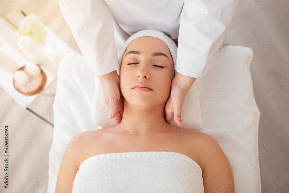 Closeup Shot Of Relaxed Indian Woman Enjoying Neck Massage At Spa Closeup Shot Of Relaxed Indian Woman Enjoying Neck Massage At Spa