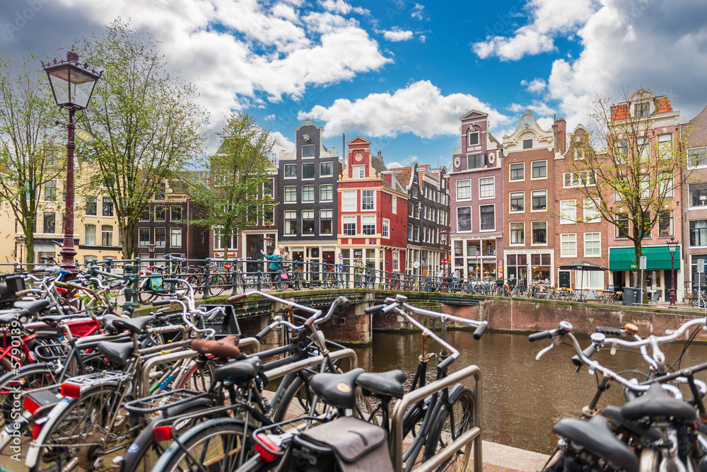 Typical Dutch facade along the canals, with many bicycles, in Amsterdam, Holland, Netherlands