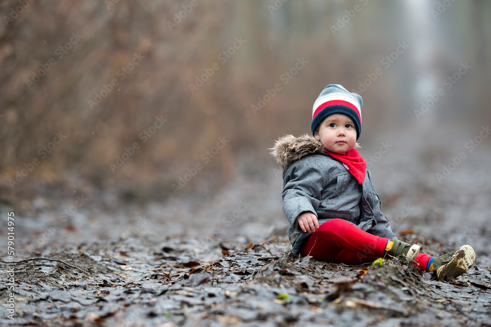 A little child is sitting through the forest A little child is sitting through the forest