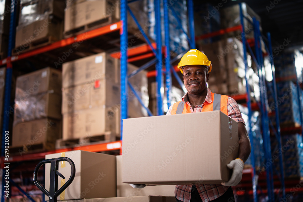 African American male warehouse worker hold cardboard box packaging in ...