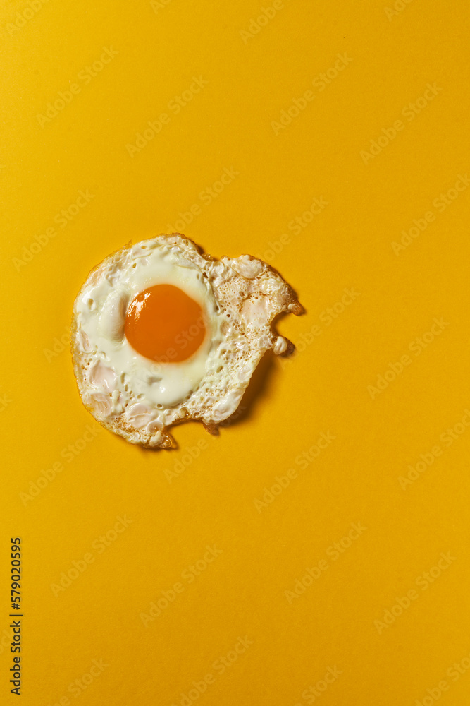 Fried egg on a yellow background Fried egg on a yellow background