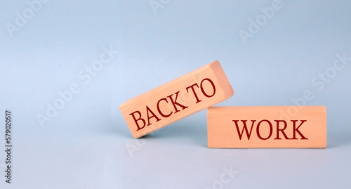 BACK TO WORK text on the wooden block, blue background