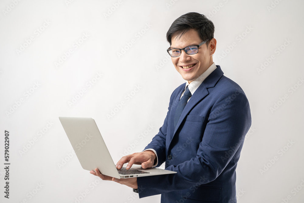 Portrait of confident Asian businessman in glasses holding laptop in hand isolated on white background Portrait of confident Asian businessman in glasses holding laptop in hand isolated on white background