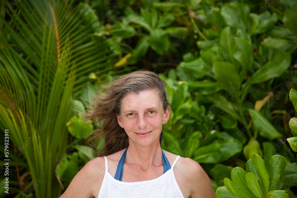 woman portrait and lush tropical greenery woman portrait and lush tropical greenery