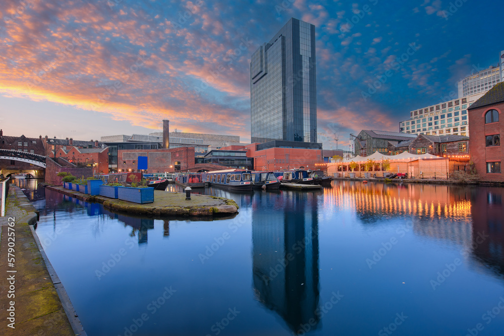 Sunset and brick buildings alongside a water canal in the central Birmingham, England