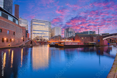 Fototapeta Naklejka Na Ścianę i Meble -  Sunset and brick buildings alongside a water canal in the central Birmingham, England