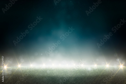 Dark nature background. Green grass and blurred bokeh. Lit place on the grass