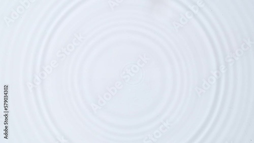 Untitled Project
Top view of water drops dripping into transparent water surface on sunlight, on white background. the water surface ripples with small waves

