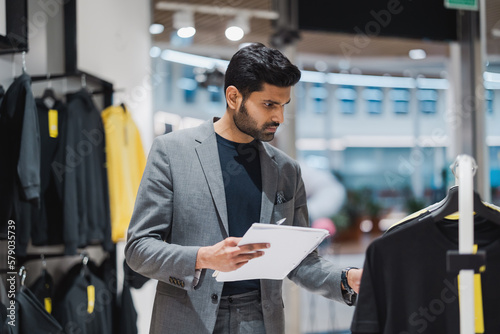 Young man working in clothing store
