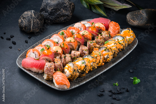 Assorted traditional Japanese sushi roll set with salmon, tuna, shrimp, eel, avocado, cream cheese, cucumber.