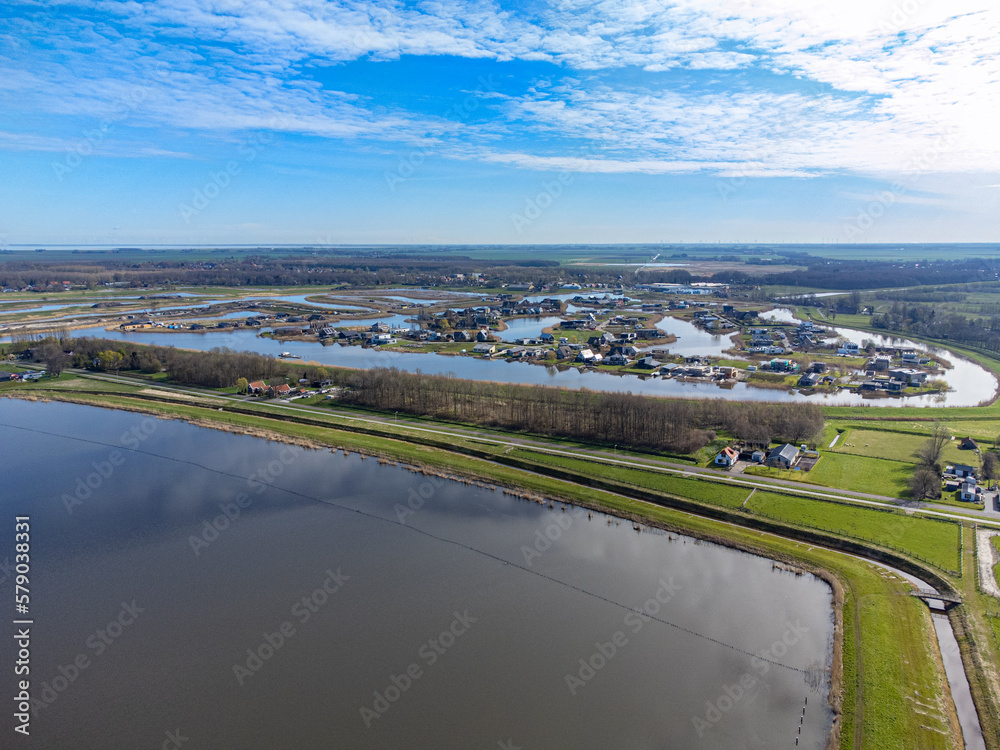aerial shot above oldambt early spring with sunny wheater with lake, water and blue sky