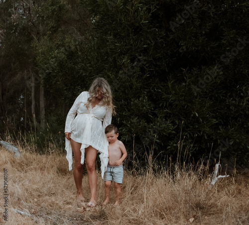 Pregnant Mother walking with son outside