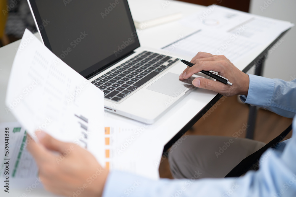 Fototapeta premium Business man working by using laptop computer Hands typing on a keyboard. Professional investor working new start up project. business planning in office. Technology business