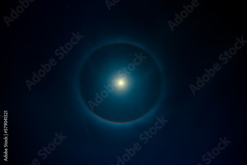 Bright moon with halo on night sky