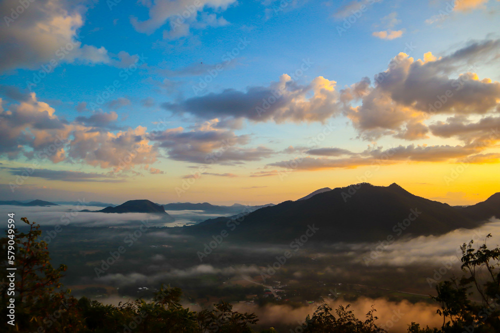 Beautiful sunset above mountains; the forest at orange sunset Beautiful sunset above mountains; the forest at orange sunset