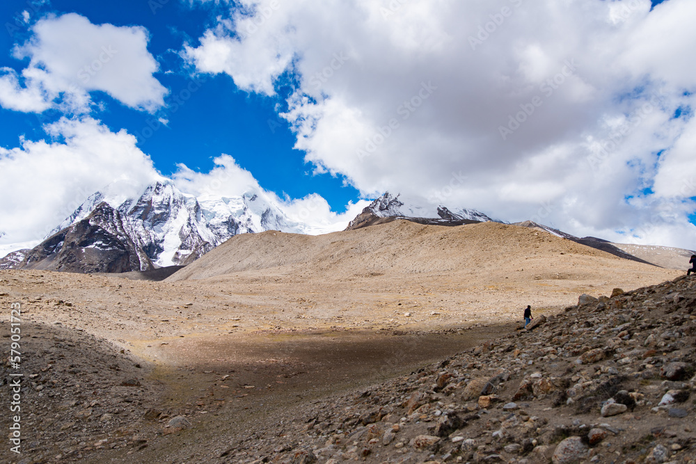 Landscape of a cold desert in Sikkim, India with Himalayan snow capped peaks in backfround.
