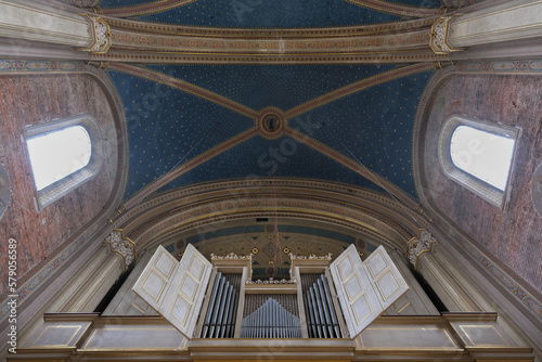 Monumental church building in Gothic in neo-romanesque arch style with large ceiling and altar murals and fresco  opulent detailed columns and marble structures