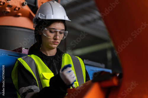 A team of female engineers meeting to inspect computer-controlled steel welding robots. Plan for rehearsals and installation for use.