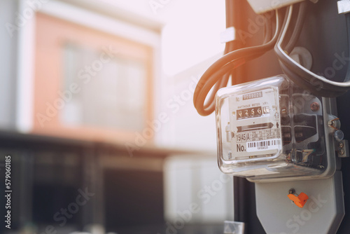 Electric power meter measuring power usage. Watt hour electric meter measurement tool at pole, outdoor electricity for use in home appliance monitor the home's electrical energy consumption.