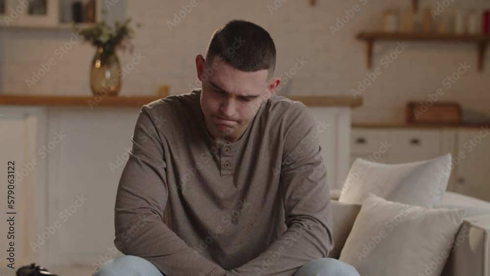 The young man, engrossed in the video game, swore loudly after failing to complete the level. A man with a short haircut was upset because he could not pass a difficult level in the game. The young man, engrossed in the video game, swore loudly after failing to complete the level. A man with a short haircut was upset because he could not pass a difficult level in the game.