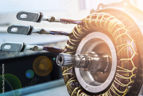 Partially disassembled for repair IPM-SynRM motor of an moder electric vehicle. EV maintenance, service; repair concept; flare effect, toned