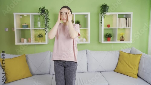 Young asian woman fainting at home.
The young woman in the house faints. Loss of balance, Dizziness.
