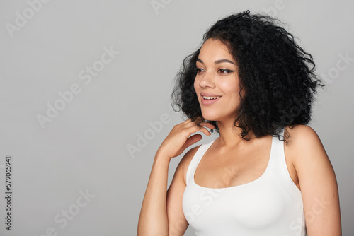 Smiling mixed race girl looking to side at blank copy space