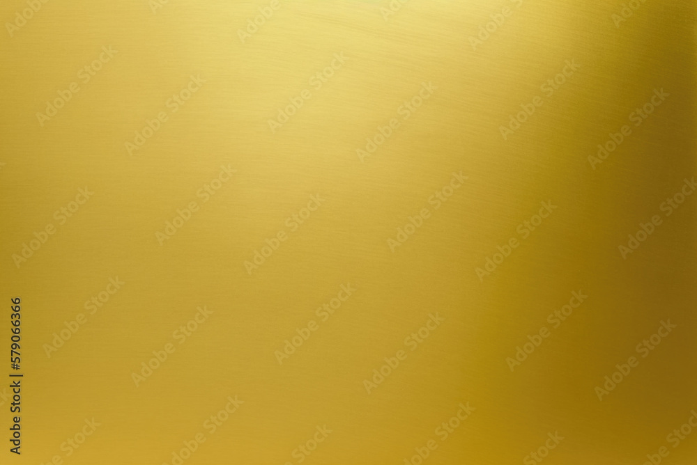 Shiny gold polished metal background texture of brushed stainless steel plate with the reflection of golden light. Shiny gold polished metal background texture of brushed stainless steel plate with the reflection of golden light.