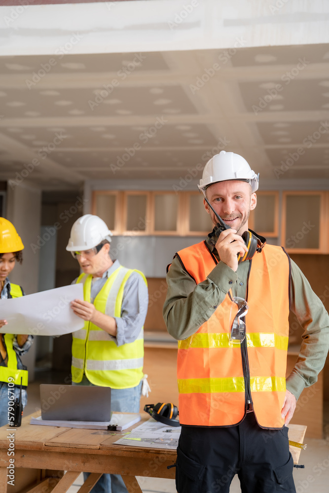 Architect colleagues mixed race working as a team discussing data working and tablet, laptop with on on architectural project at construction site at desk. Architect colleagues mixed race working as a team discussing data working and tablet, laptop with on on architectural project at construction site at desk.