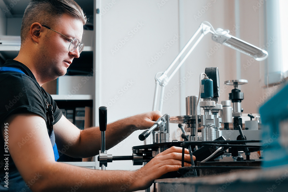 Professional calibration of pressure gauges and sensors. Working man is engaged in verification of control and measuring devices at workplace.. Professional calibration of pressure gauges and sensors. Working man is engaged in verification of control and measuring devices at workplace..