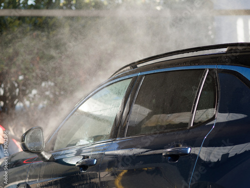 washing blue suv at car wash