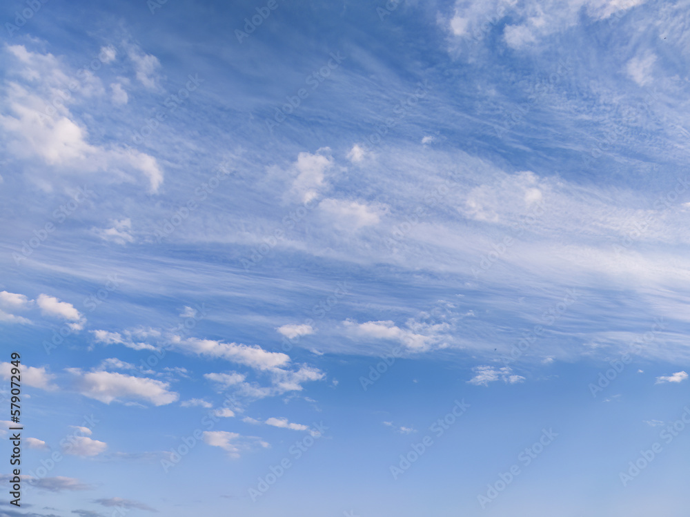 Blue sky with beautiful fluffy clouds; background of cloudy sky