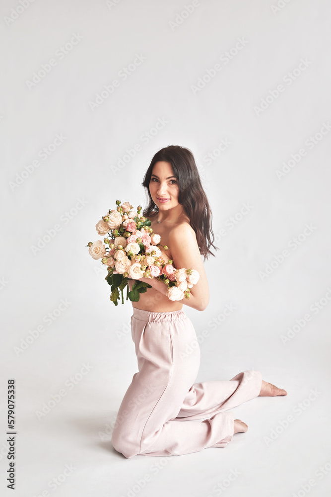 Beautiful young woman with bouquet flowers of roses. International Women's Day. Beautiful young woman with bouquet flowers of roses. International Women's Day.