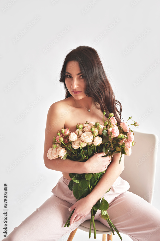 Beautiful young woman with bouquet flowers of roses. International Women's Day. Beautiful young woman with bouquet flowers of roses. International Women's Day.