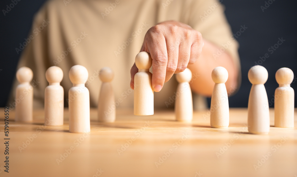 HR or manager hand choose a figure standing out from the crowd. Business hiring and recruitment selection. Choice of employee lead. Career opportunity, Good worker. Human Resource Management concept. HR or manager hand choose a figure standing out from the crowd. Business hiring and recruitment selection. Choice of employee lead. Career opportunity, Good worker. Human Resource Management concept.