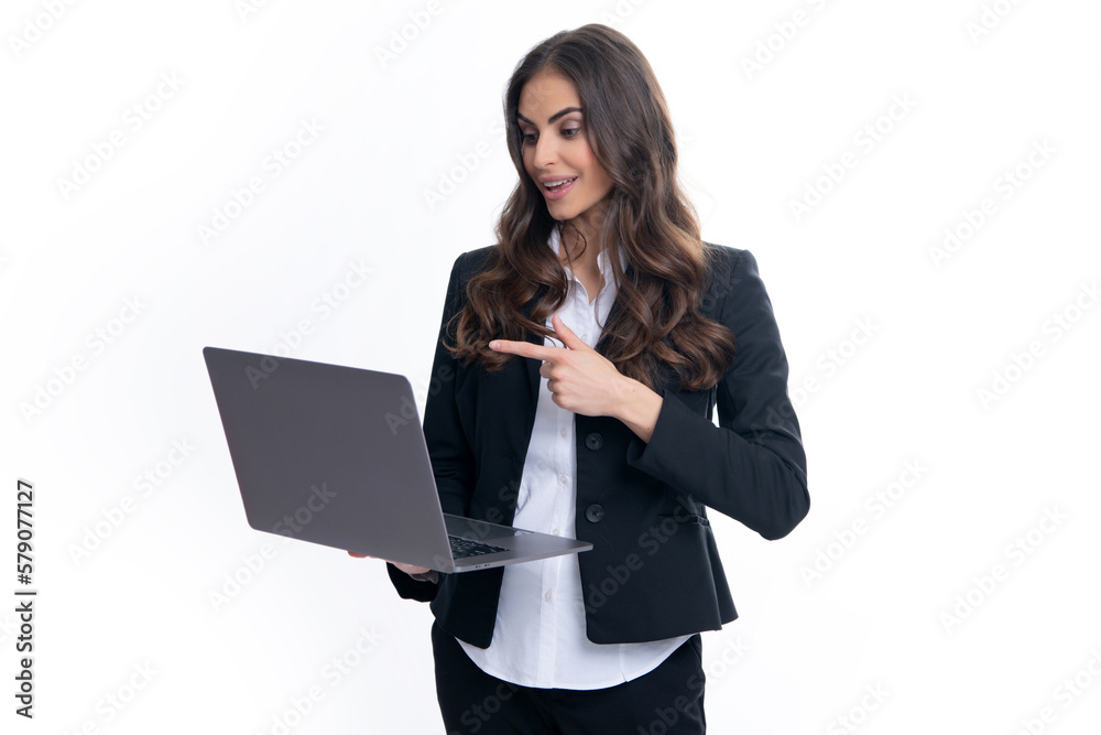 Portrait of a cheerful young casual girl standing isolated over gray background, using laptop computer. Business woman at work. Portrait of a cheerful young casual girl standing isolated over gray background, using laptop computer. Business woman at work.