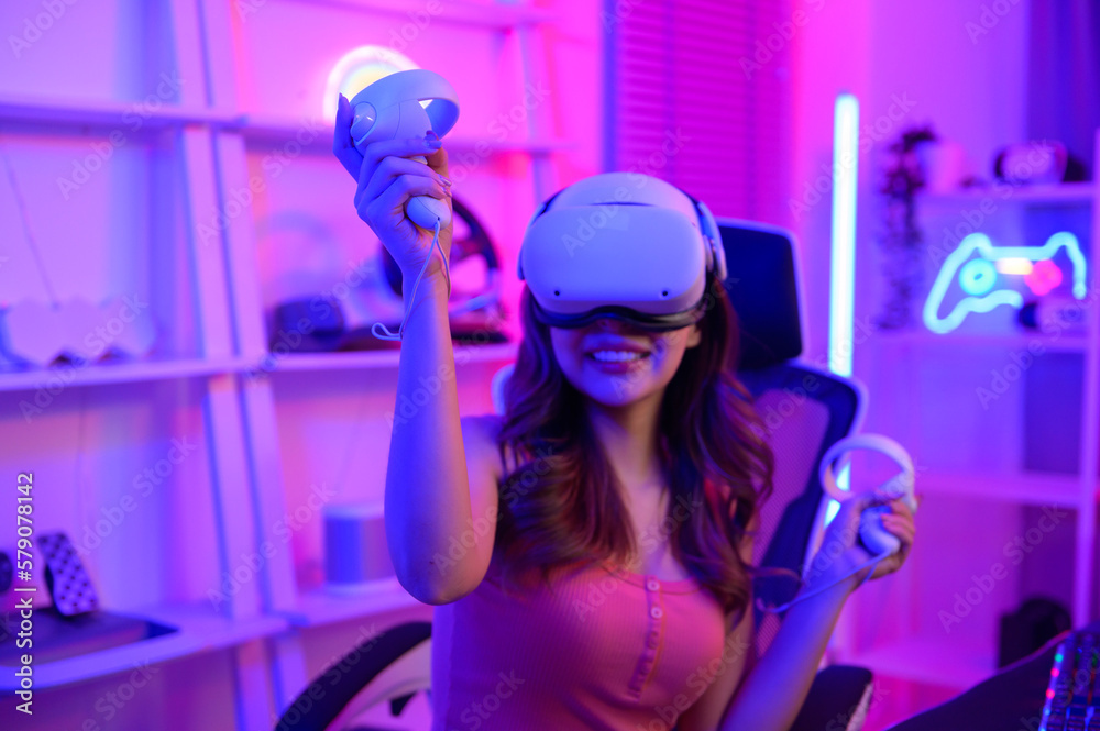 Young Asian pretty woman Pro Gamer have live streaming playing video game, using virtual reality glasses at home Young Asian pretty woman Pro Gamer have live streaming playing video game, using virtual reality glasses at home