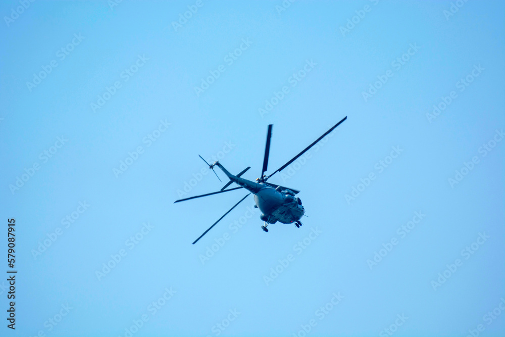 Military helicopters is flying against isolated blue sky Military helicopters is flying against isolated blue sky
