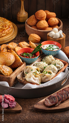 Set of assorted oriental cuisine dishes with samsa and manti