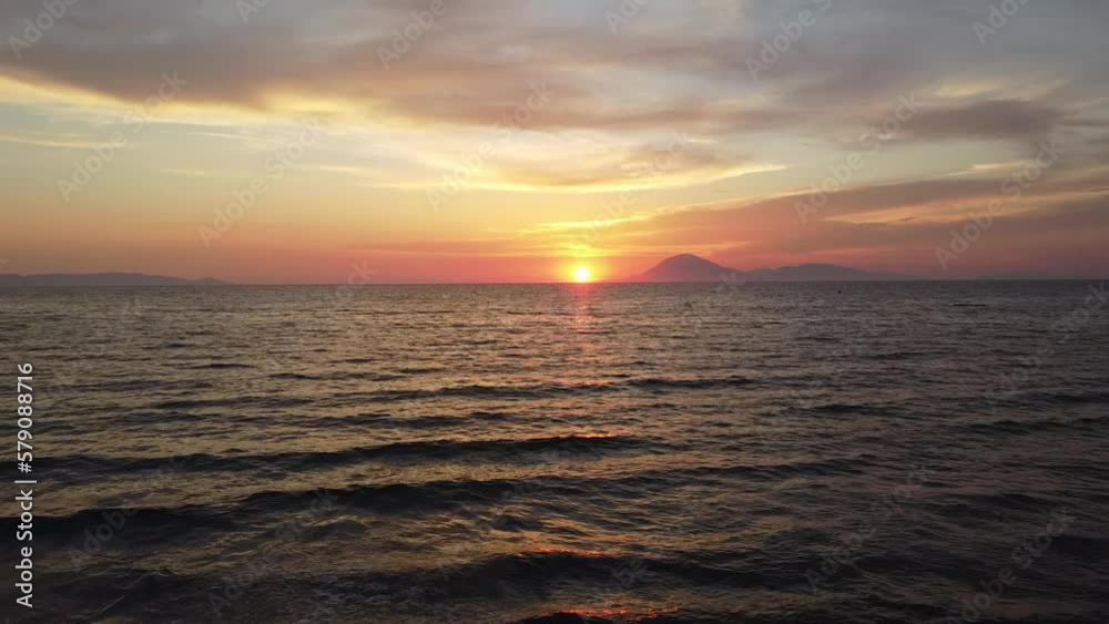 Incredible sunset scenery in Greece. Flying into the sunset. View to island of Kefalonia. Shot in Kyllini Beach. Incredible sunset scenery in Greece. Flying into the sunset. View to island of Kefalonia. Shot in Kyllini Beach.