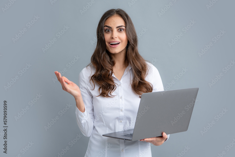 Blogging chatting woman. Beautiful smiling business woman over grey background using laptop computer. Blogging chatting woman. Beautiful smiling business woman over grey background using laptop computer.