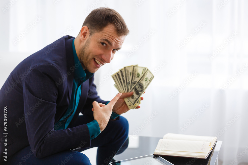 Young business man working at home with laptop and papers on desk. Young business man working at home with laptop and papers on desk.