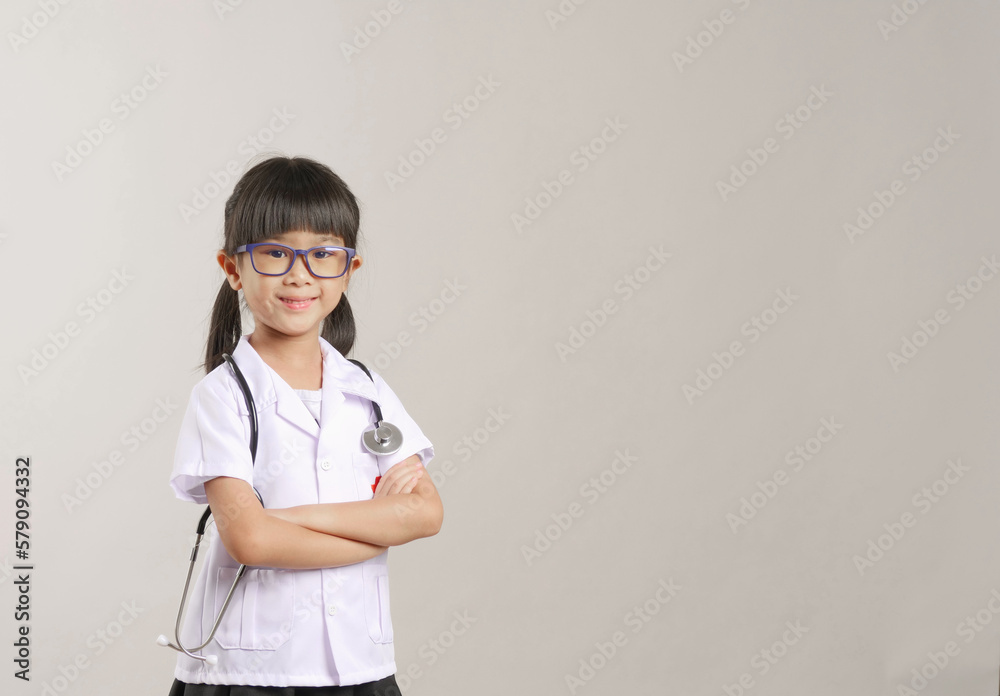 Kid doctor holding a stethoscope. Kid role playing doctor.
Kid doctor holding a stethoscope. Kid role playing doctor.